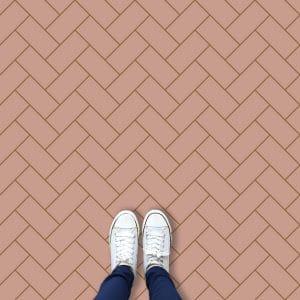 Image of a bespoke pink herringbone vinyl flooring only available from forthefloorandmore.com
