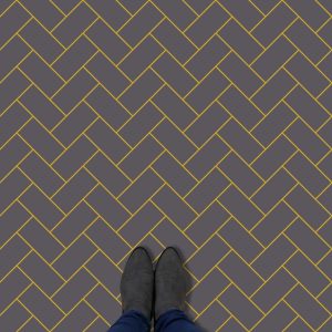 Image of a bespoke charcoal and mustard herringbone vinyl flooring only available from forthefloorandmore.com