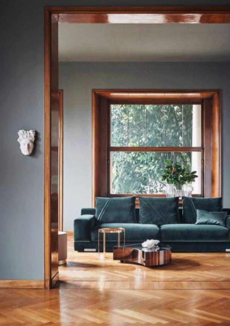 Image of a herringbone lounge flooring installation used in a blog post by forthefloorandmore.com