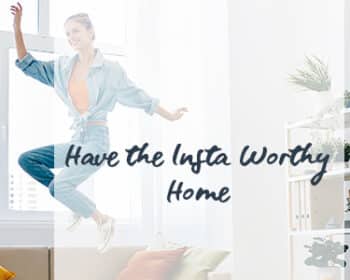 Image of a woman jumping on her sofa used in a blog post for how to have an Instagram worthy home. Top tips on how to create the best home decor Instagram posts.