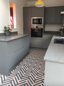 Kitchen with herringbone vinyl floor and light cabinets