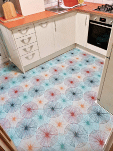 Kitchen with bold patterned floor and neutral cabinets