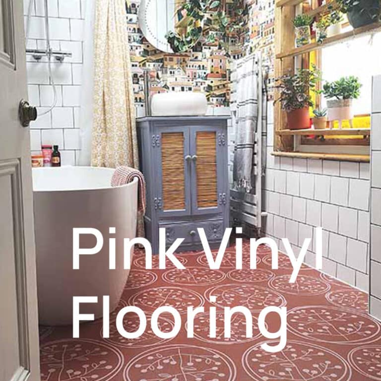 A bathroom with a freestanding bath, a blue cabinet and a pink patterned vinyl floor