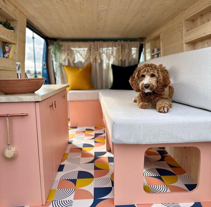 Sheet vinyl flooring in a campervan with timber panelling, upholstery and cabinetry