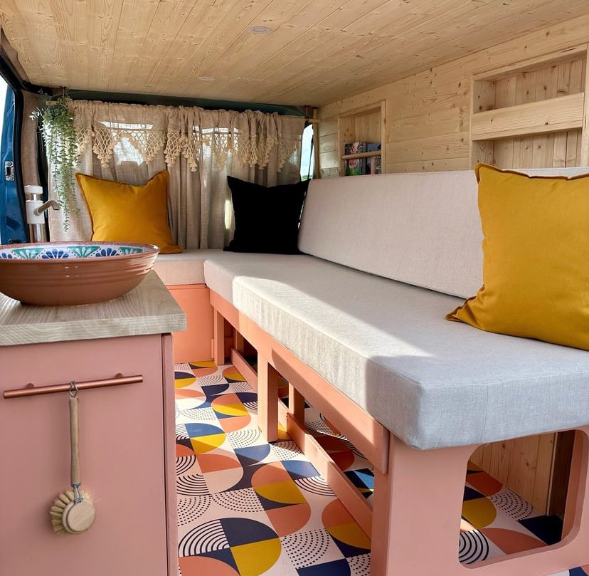 Patterned vinyl flooring in a campervan with timber, upholstery and cabinetry